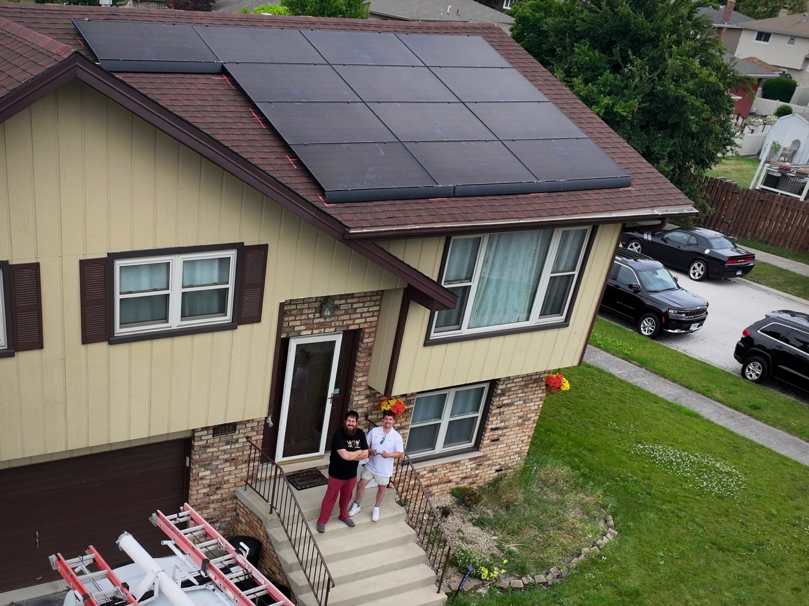 Homeowners in front of house